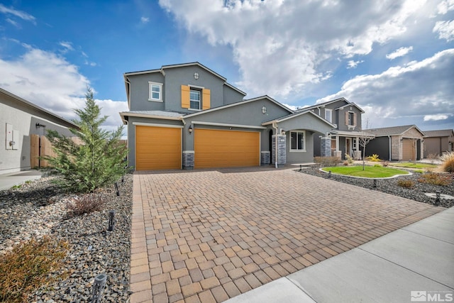 2181 Wyaconda Dr, Sparks, NV 89436 - view of front of home featuring stucco siding, decorative driveway, stone siding, fence, and an attached garage