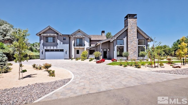 4060 Goodsell Ln, Reno, NV 89523 - modern farmhouse featuring board and batten siding, a chimney, an attached garage, and curved driveway