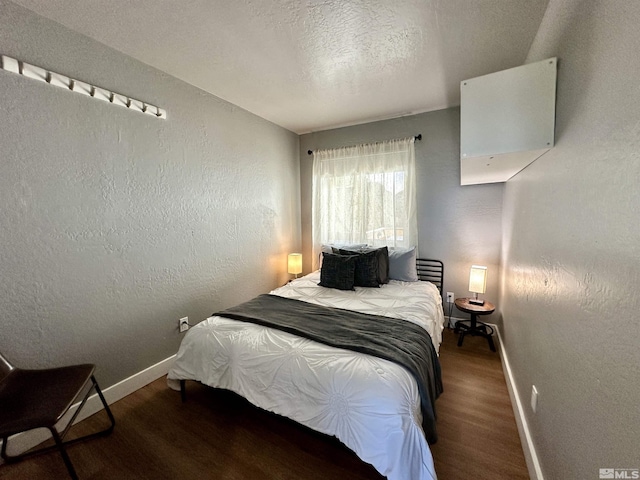 261 Quaking Aspen Ln Unit B, Stateline, NV 89449 - bedroom featuring baseboards, wood finished floors, a textured wall, and a textured ceiling