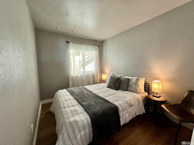 261 Quaking Aspen Ln Unit B, Stateline, NV 89449 - bedroom with dark wood-type flooring, a textured wall, and baseboards