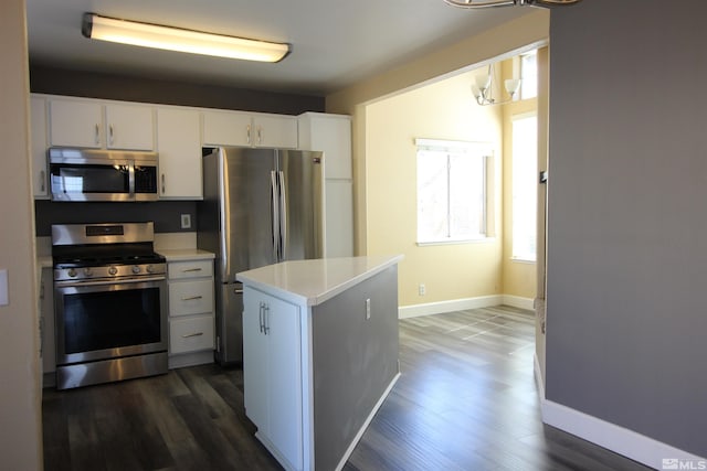 495 Len Cir, Reno, NV 89511 - kitchen with appliances with stainless steel finishes, light countertops, baseboards, and dark wood-type flooring