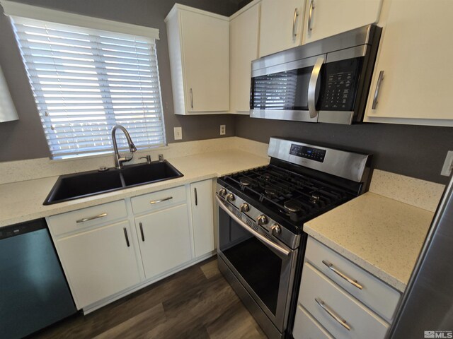 495 Len Cir, Reno, NV 89511 - kitchen with appliances with stainless steel finishes, a sink, dark wood finished floors, and white cabinetry