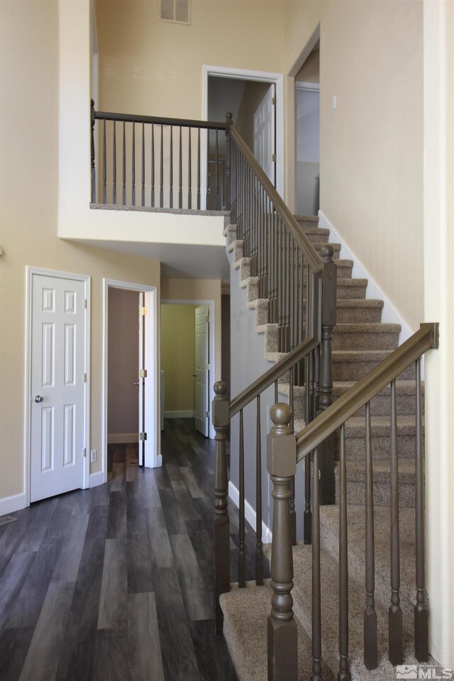 495 Len Cir, Reno, NV 89511 - staircase featuring baseboards, wood finished floors, and a towering ceiling