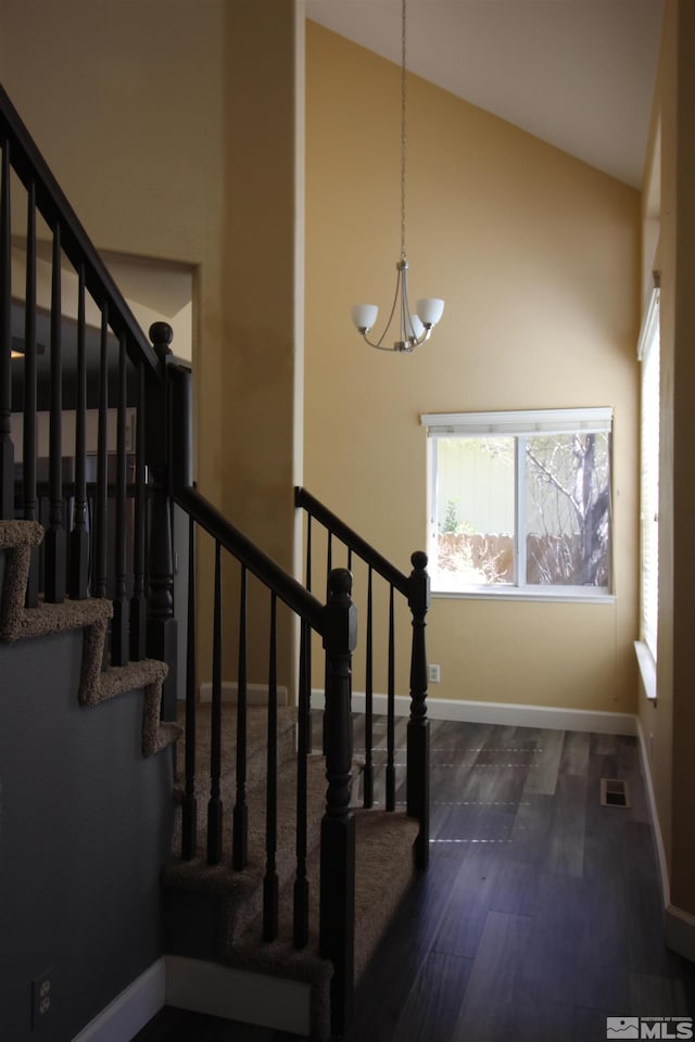 495 Len Cir, Reno, NV 89511 - staircase featuring healthy amount of natural light, a chandelier, wood finished floors, baseboards, and high vaulted ceiling