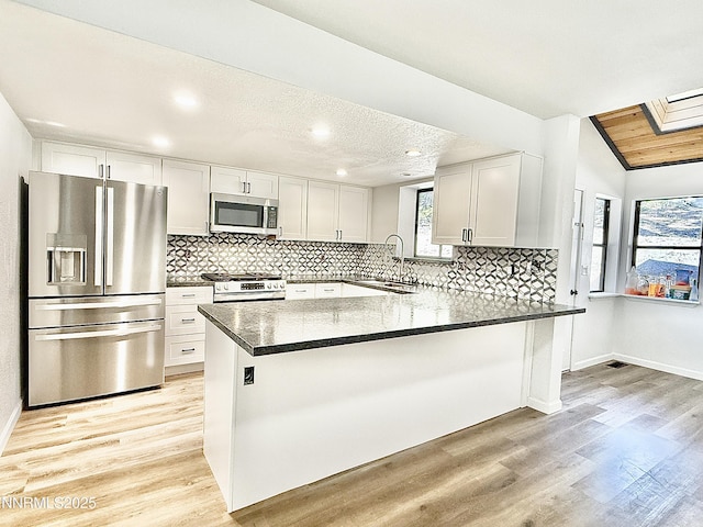 449 Andria Dr, Stateline, NV 89448 - kitchen featuring stainless steel appliances, a sink, tasteful backsplash, light wood-style floors, and recessed lighting