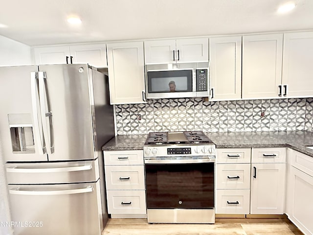 449 Andria Dr, Stateline, NV 89448 - kitchen featuring appliances with stainless steel finishes, white cabinets, light wood-style floors, and decorative backsplash