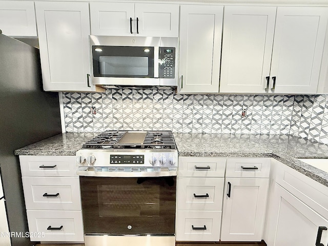 449 Andria Dr, Stateline, NV 89448 - kitchen with stainless steel appliances, white cabinetry, backsplash, and light stone countertops