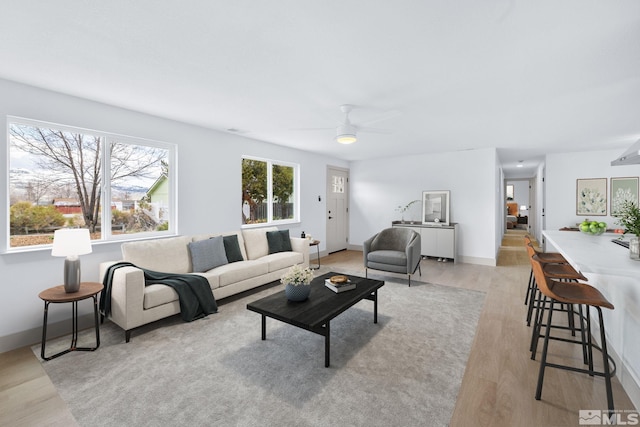 3575 Gull St, Reno, NV 89508 - living room featuring light wood-style floors, a ceiling fan, and baseboards