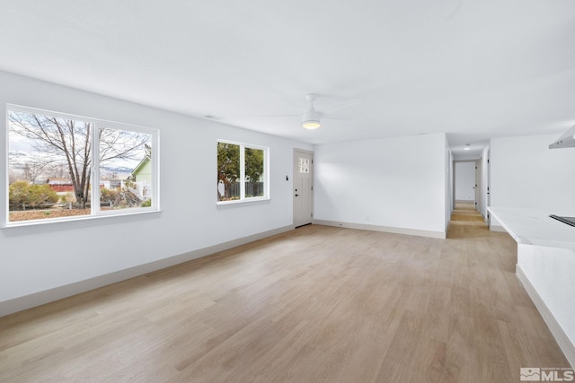 3575 Gull St, Reno, NV 89508 - unfurnished living room with light wood-style flooring, a ceiling fan, and baseboards