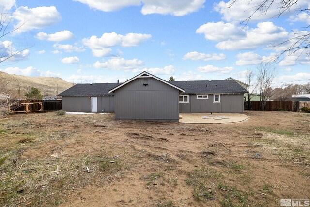 3575 Gull St, Reno, NV 89508 - rear view of house featuring fence, a patio, and a mountain view