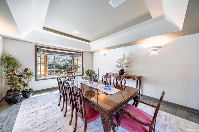 1185 Paddock Ln, Reno, NV 89521 - dining area with a tray ceiling, baseboards, and stone finish flooring