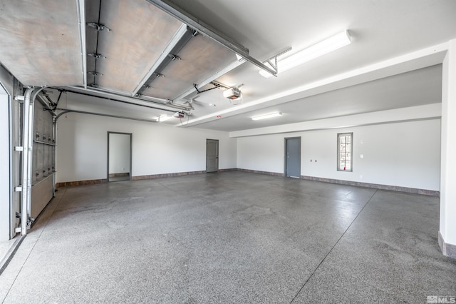 1185 Paddock Ln, Reno, NV 89521 - garage with a garage door opener and baseboards