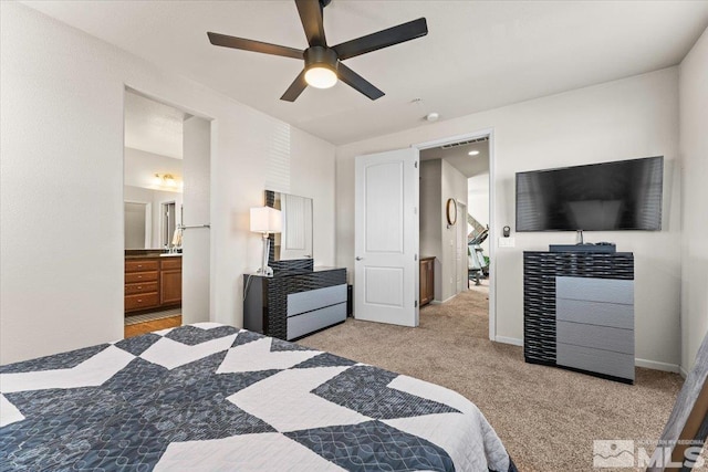 bedroom with light carpet, ceiling fan, and connected bathroom