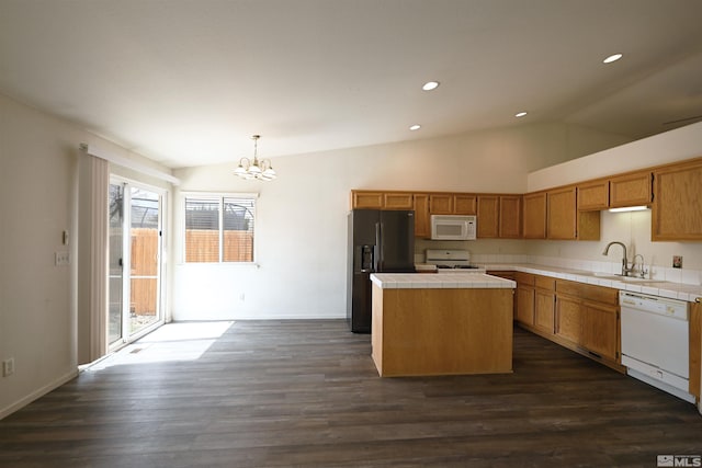 2129 Fort Bridger, Fernley, NV 89408 - kitchen with white appliances, tile counters, a chandelier, a sink, and vaulted ceiling