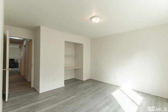 2225 Figoni Ranch Rd, Sparks, NV 89434 - unfurnished bedroom with wood finished floors, a closet, and baseboards