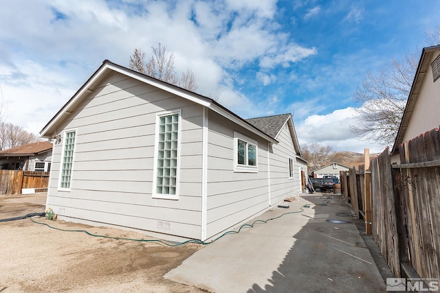 2225 Figoni Ranch Rd, Sparks, NV 89434 - view of property exterior featuring fence, a patio area, and roof with shingles