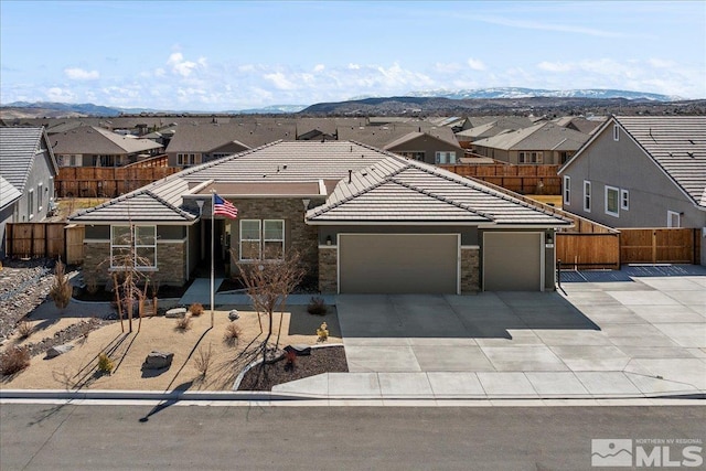 908 Sand Springs Dr, Sparks, NV 89441 - view of front of property featuring a garage, a tiled roof, concrete driveway, stone siding, and a residential view