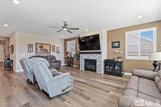 908 Sand Springs Dr, Sparks, NV 89441 - living room with wood finished floors, baseboards, ceiling fan, a stone fireplace, and recessed lighting