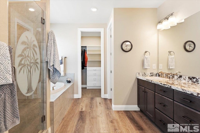 908 Sand Springs Dr, Sparks, NV 89441 - full bath with a stall shower, wood finished floors, vanity, a walk in closet, and a bath
