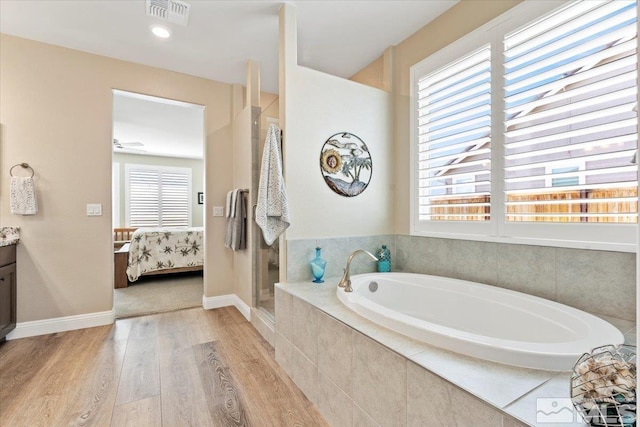 908 Sand Springs Dr, Sparks, NV 89441 - ensuite bathroom with wood finished floors, a bath, vanity, walk in shower, and baseboards