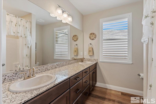 908 Sand Springs Dr, Sparks, NV 89441 - full bath with baseboards, wood finished floors, healthy amount of natural light, and double vanity