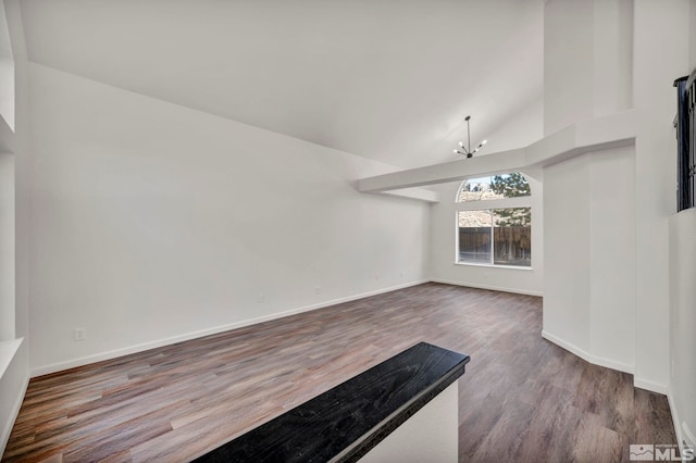 2510 Wolf Creek Dr, Reno, NV 89523 - unfurnished living room with a chandelier, wood finished floors, baseboards, and high vaulted ceiling