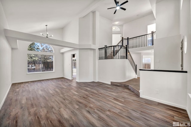 2510 Wolf Creek Dr, Reno, NV 89523 - unfurnished living room with high vaulted ceiling, wood finished floors, baseboards, ceiling fan, and a chandelier