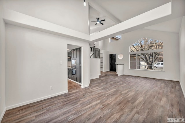 2510 Wolf Creek Dr, Reno, NV 89523 - unfurnished living room featuring high vaulted ceiling, wood finished floors, ceiling fan, and baseboards