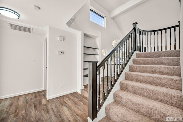 2510 Wolf Creek Dr, Reno, NV 89523 - stairs featuring wood finished floors, baseboards, and a high ceiling
