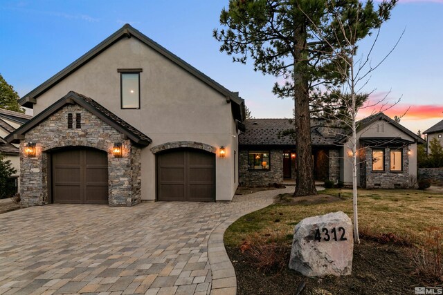 4312 Beaujolais St, Reno, NV 89511 - view of front of property with decorative driveway, stone siding, stucco siding, a garage, and a front lawn