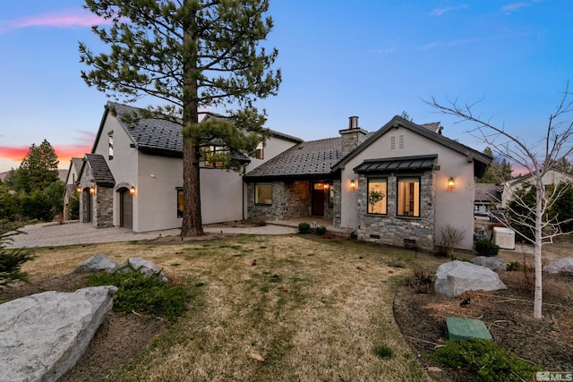 4312 Beaujolais St, Reno, NV 89511 - back of property with stone siding, stucco siding, and a chimney