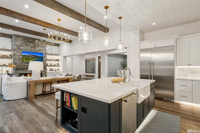 4312 Beaujolais St, Reno, NV 89511 - kitchen with stainless steel appliances, open floor plan, a sink, white cabinetry, and beamed ceiling