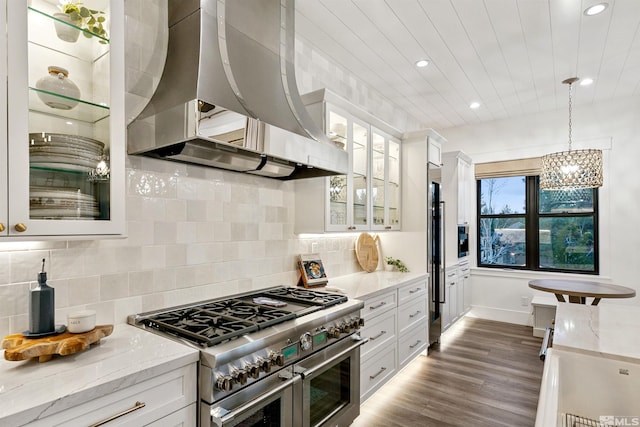 4312 Beaujolais St, Reno, NV 89511 - kitchen with high quality appliances, wall chimney exhaust hood, white cabinets, wood finished floors, and glass insert cabinets
