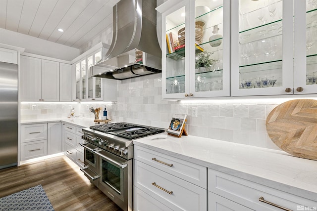 4312 Beaujolais St, Reno, NV 89511 - kitchen featuring premium appliances, wall chimney range hood, dark wood finished floors, white cabinetry, and light stone countertops