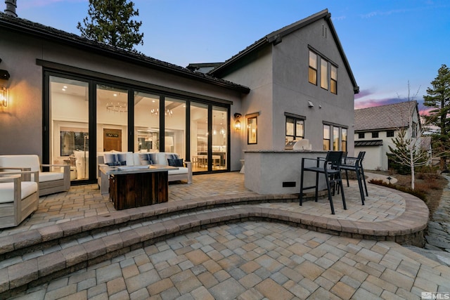 4312 Beaujolais St, Reno, NV 89511 - rear view of house featuring a patio area, an outdoor living space with a fire pit, and stucco siding
