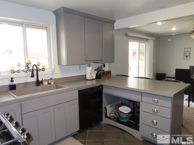 kitchen with dishwasher, a sink, a peninsula, and gray cabinets