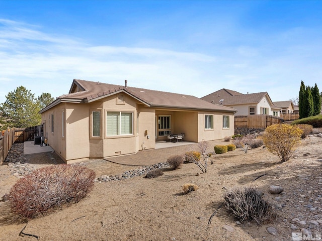 3502 Painted Vista Dr, Reno, NV 89511 - back of house with a patio area, stucco siding, and a fenced backyard