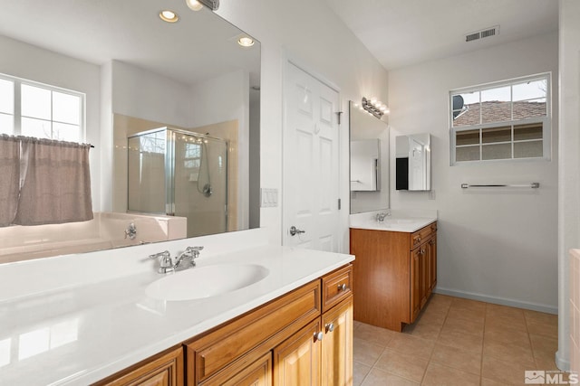 1853 Resistol Dr, Reno, NV 89521 - bathroom with plenty of natural light, a stall shower, two vanities, tile patterned flooring, and recessed lighting