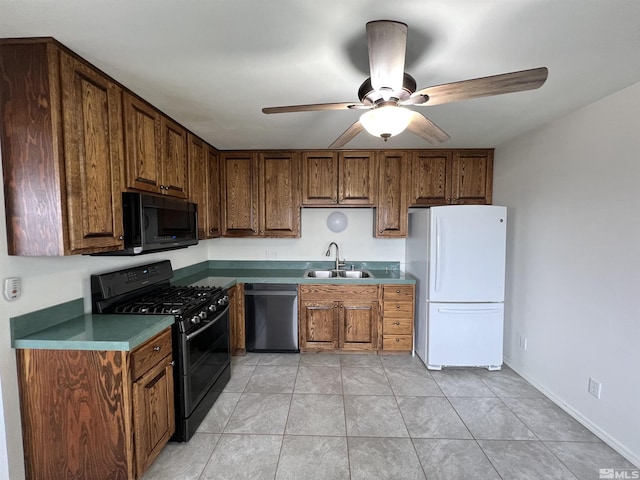 kitchen featuring black appliances, a sink, a ceiling fan, light tile patterned flooring, and brown cabinets