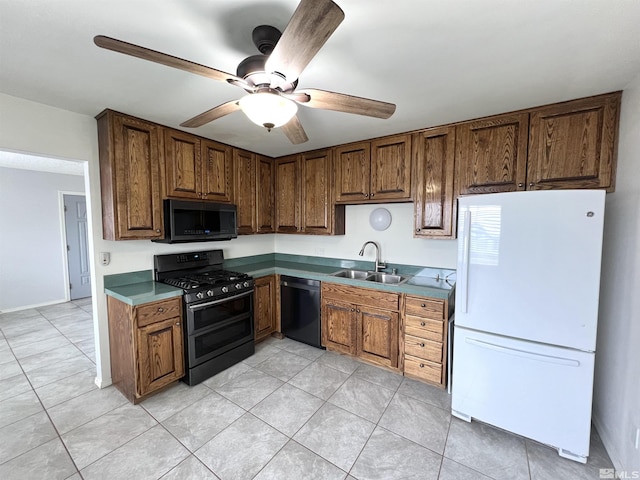 kitchen featuring black appliances, a sink, a ceiling fan, and light tile patterned floors