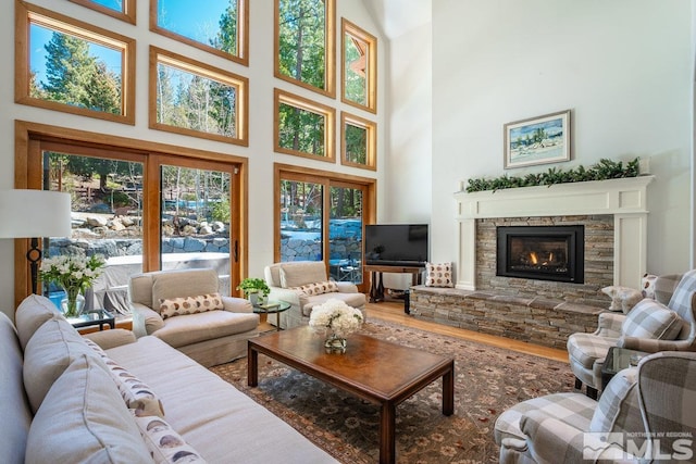2147 The Back Rd, Glenbrook, NV 89413 - living room with a towering ceiling, wood finished floors, and a stone fireplace