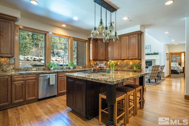 2147 The Back Rd, Glenbrook, NV 89413 - kitchen with stainless steel appliances, a kitchen bar, a kitchen island, stone counters, and decorative backsplash