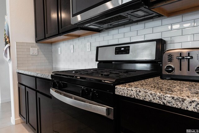 7216 Mustengo Dr, Reno, NV 89506 - kitchen with appliances with stainless steel finishes, light stone countertops, and tasteful backsplash