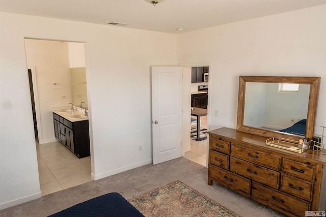 7216 Mustengo Dr, Reno, NV 89506 - bedroom with light carpet, light tile patterned floors, a sink, and baseboards