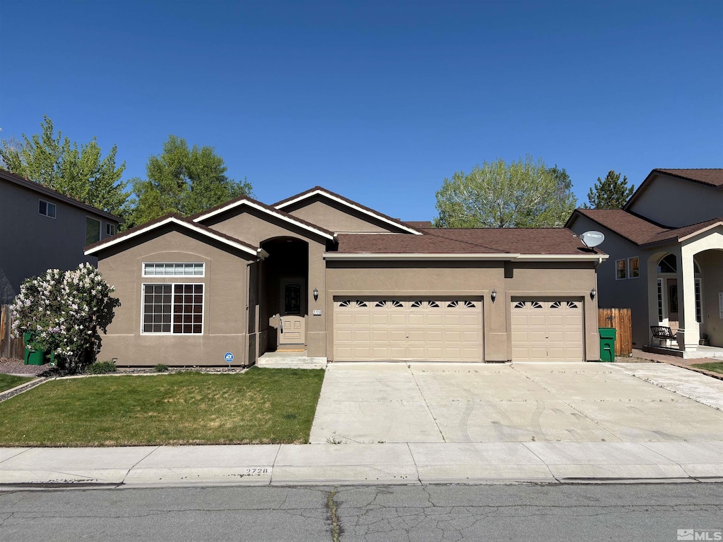 2728 Table Rock Dr, Carson City, NV 89706 - ranch-style house with an attached garage, stucco siding, driveway, and a front lawn