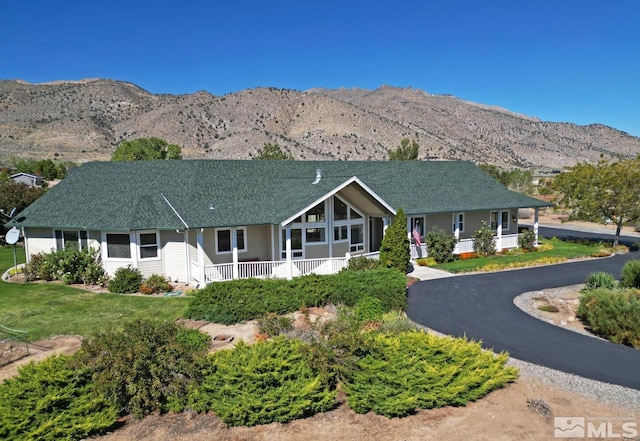 45 Lower Colony Rd, Wellington, NV 89444 - view of front of house featuring covered porch, a mountain view, a shingled roof, and a front lawn