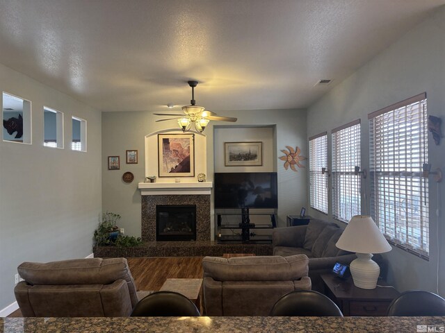 10316 Sterling View Ct, Reno, NV 89521 - living room with wood finished floors, healthy amount of natural light, ceiling fan, and a fireplace