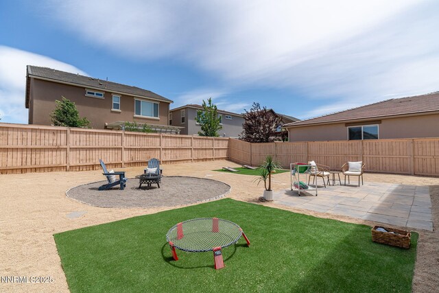 9726 Pachuca Dr, Reno, NV 89521 - fenced backyard with an outdoor fire pit and a patio