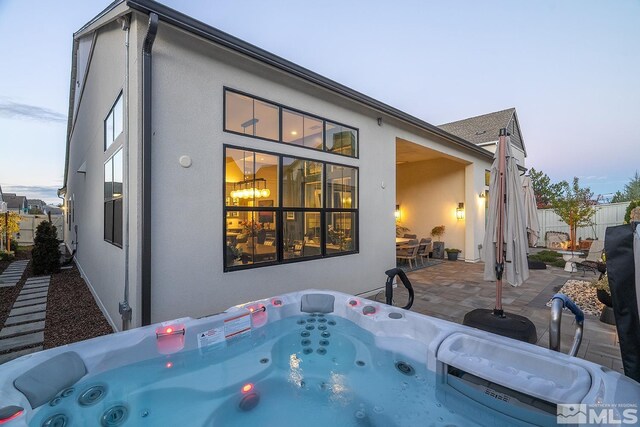 720 Marewood Trl, Reno, NV 89511 - rear view of house featuring a hot tub, a patio area, stucco siding, and fence