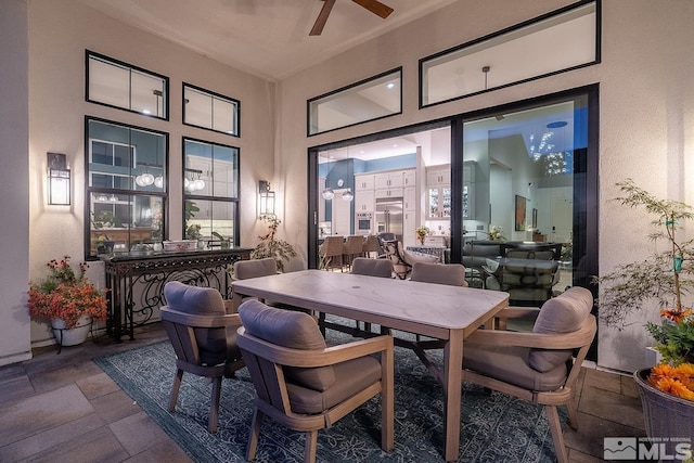 720 Marewood Trl, Reno, NV 89511 - dining area featuring ceiling fan, stone tile flooring, and a towering ceiling